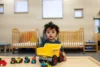 child playing with toy truck